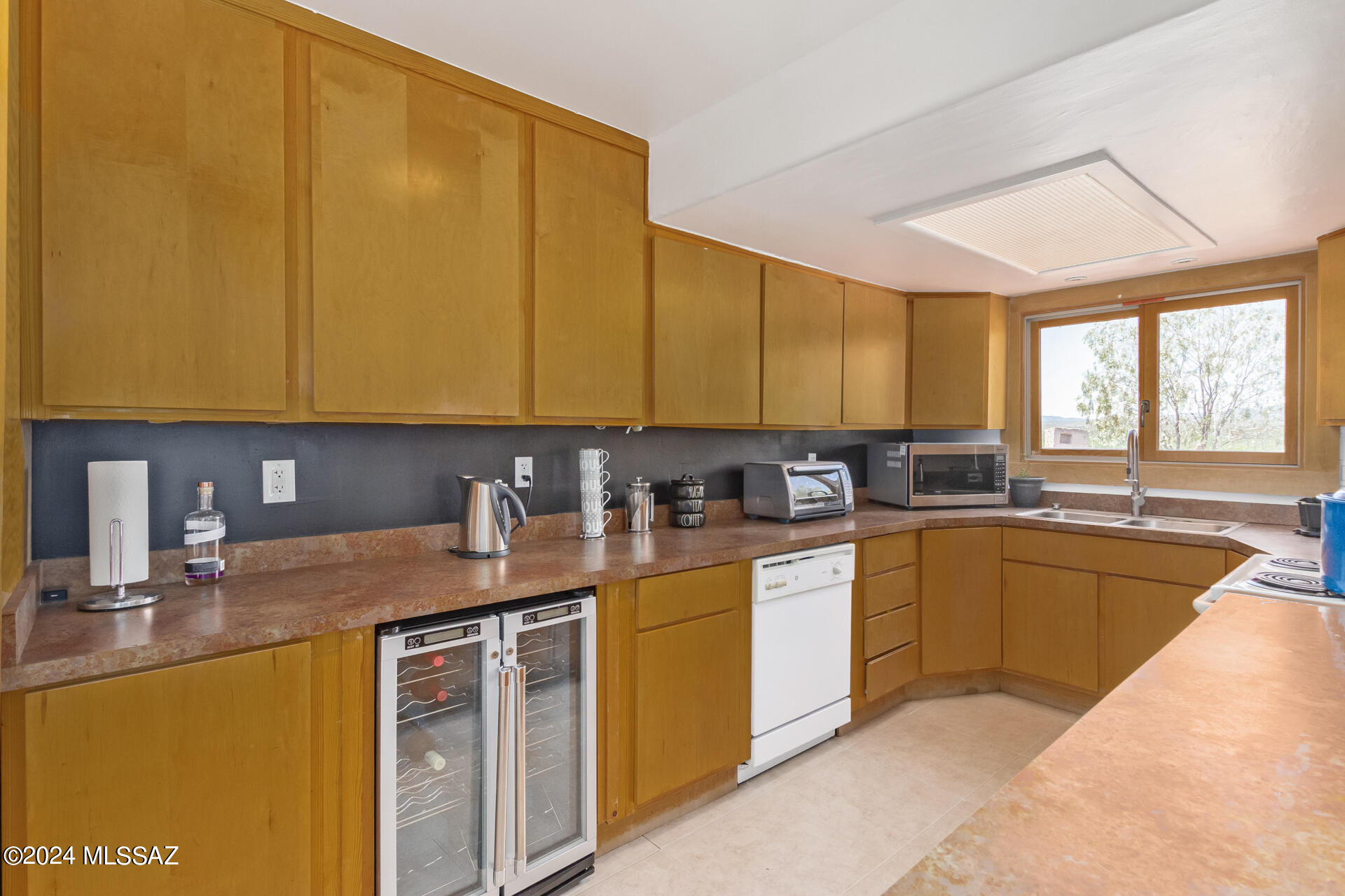 1242 Dodo Court Rio Rico, AZ 85648 - Photo 18 of 46 a kitchen with stainless steel appliances granite countertop a sink a stove and cabinets