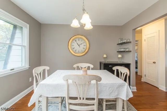 a view of a dining room with furniture and a large window