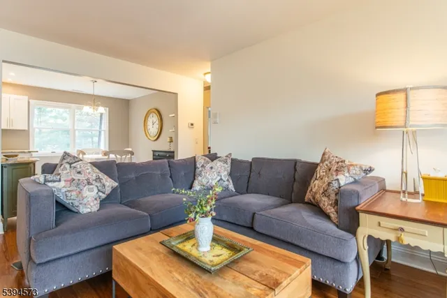 a living room with furniture wooden floor and a large window
