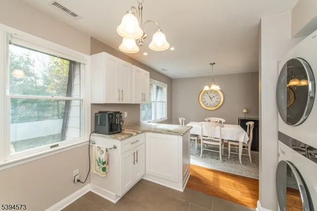 a living room with furniture a fireplace and a large window