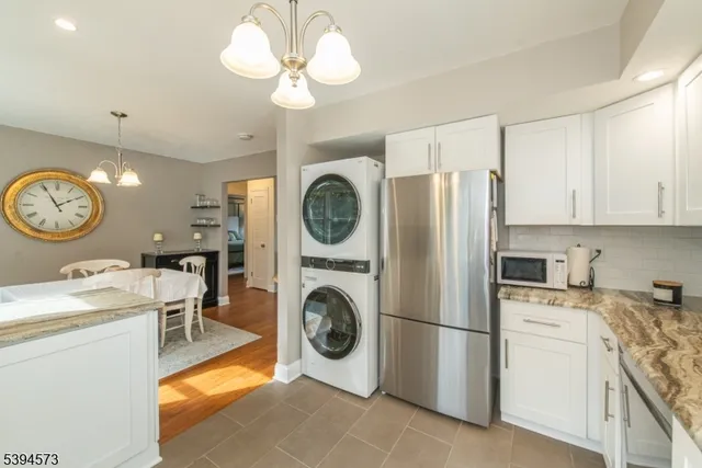 a view of a kitchen with a stove top oven and cabinets