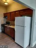 a kitchen with a refrigerator and a stove