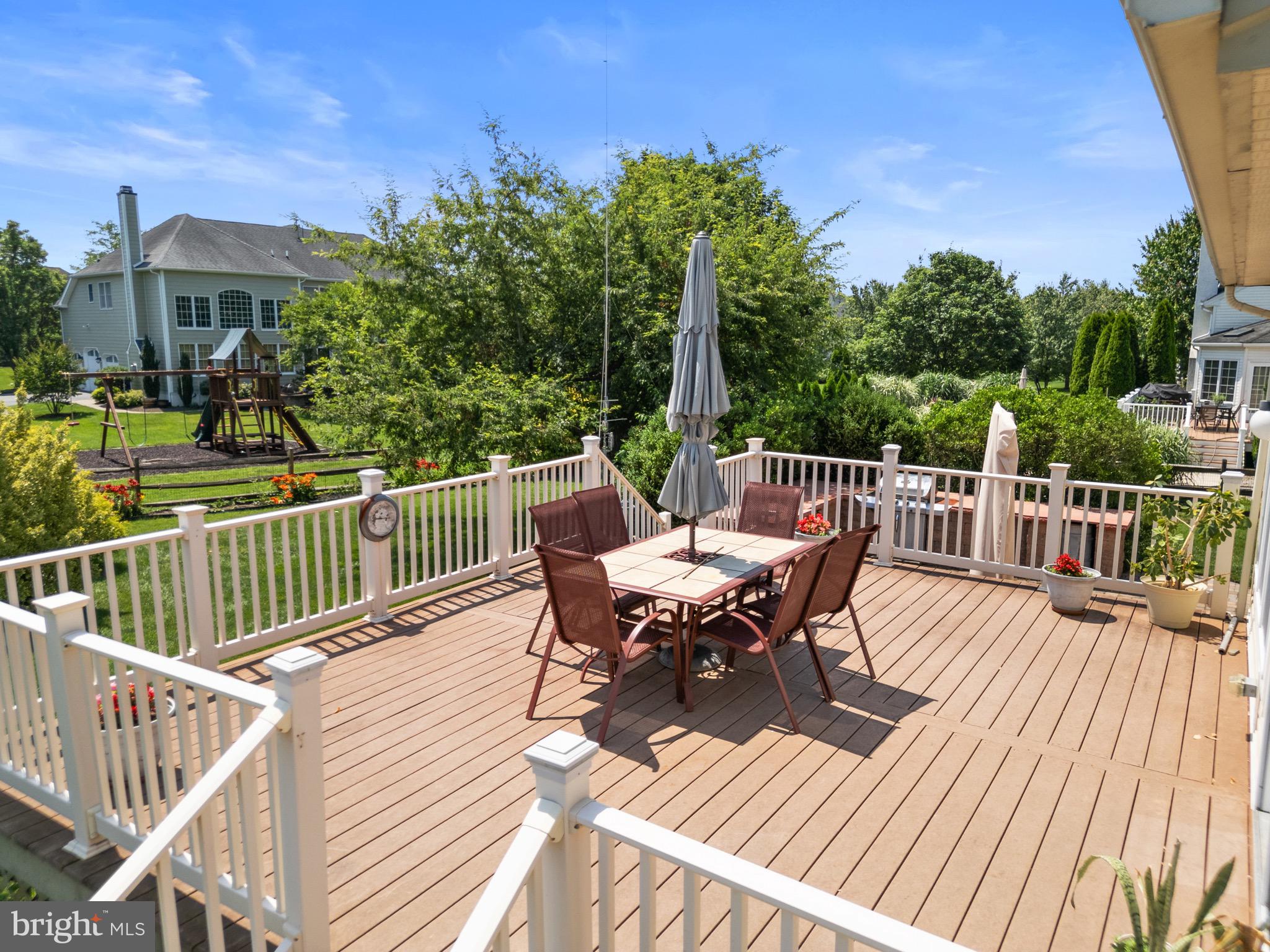907 Mather Drive Bear, DE 19701 - Photo 10 of 80 a view of a roof deck with table and chairs and wooden floor