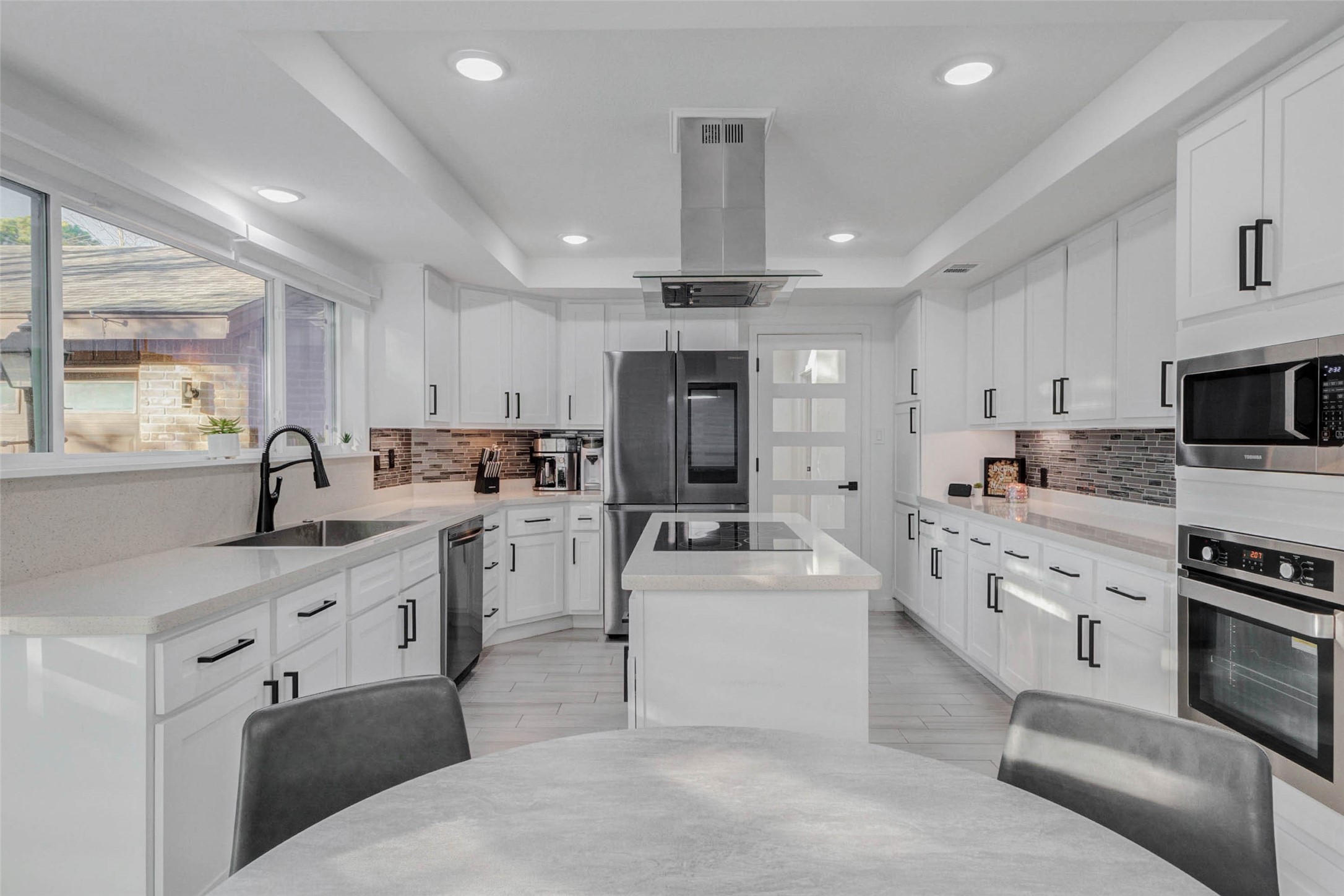 2223 Foreland Drive Houston, TX 77077 - Photo 13 of 39 a kitchen with white cabinets and white appliances