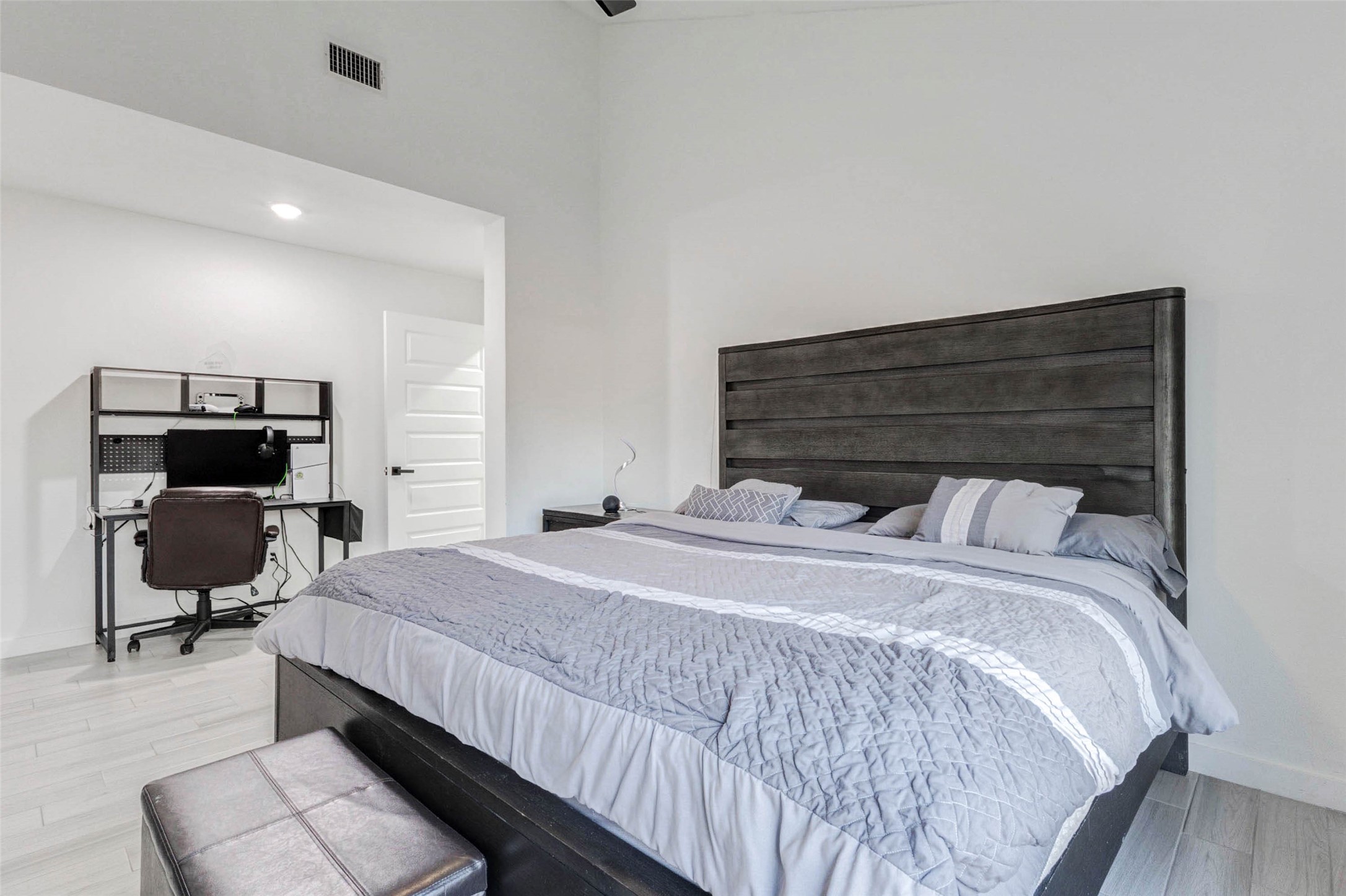 2223 Foreland Drive Houston, TX 77077 - Photo 29 of 39 a bedroom with a bed a chair and glass door