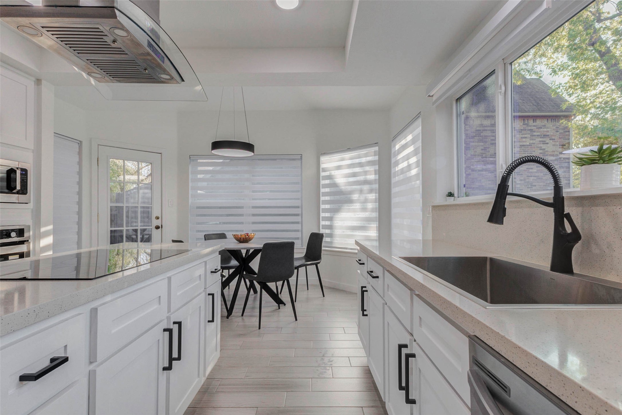 2223 Foreland Drive Houston, TX 77077 - Photo 9 of 39 a kitchen with sink a large window and chairs