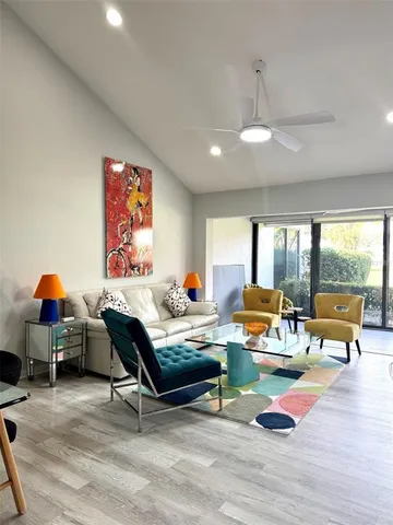 a living room with furniture and wooden floor