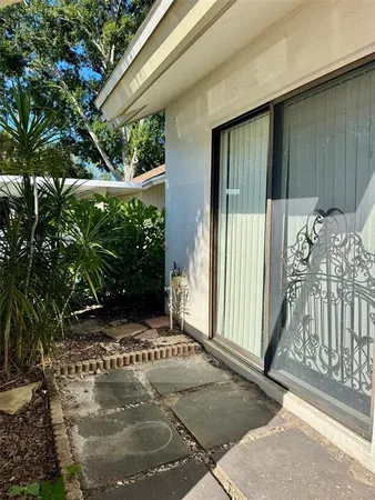 a living room with furniture and floor to ceiling window