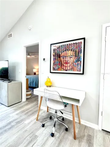 a bedroom with a bed a large window and walk in closet