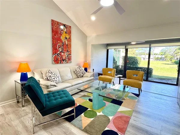 a living room with furniture and wooden floor
