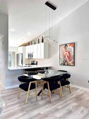 a bedroom with a bed and large windows