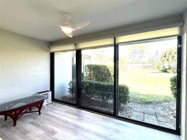 a bedroom with a bed a large window and walk in closet