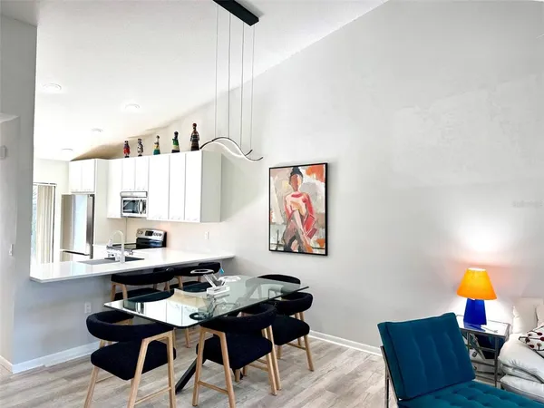 a dining room with table chairs and wooden floor