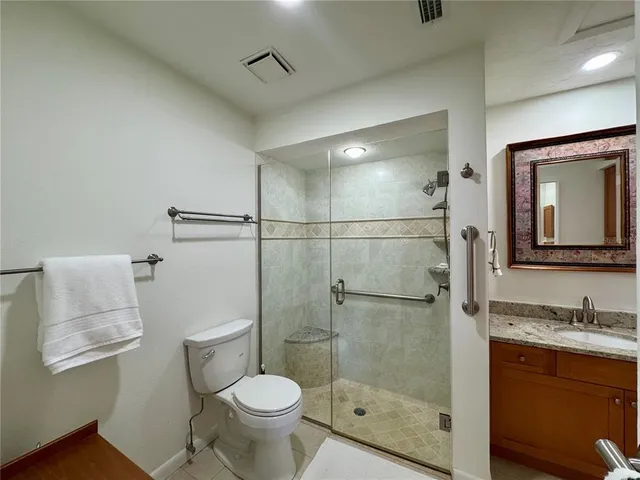 a bathroom with a granite countertop sink mirror vanity and bathtub