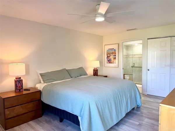 a bedroom with a bed and wooden floor