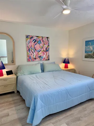 a view of a yard with plants and trees