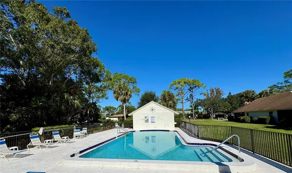 a view of a swimming pool with an outdoor space and seating area