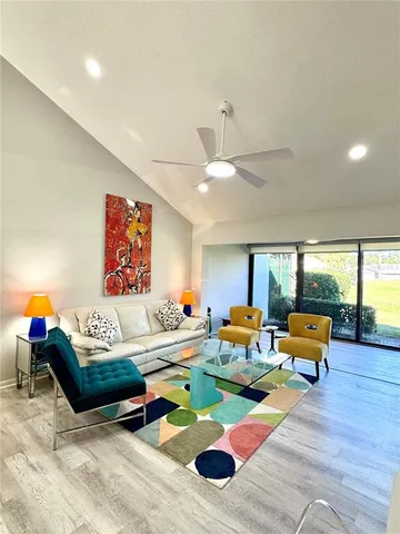 a living room with furniture and floor to ceiling window