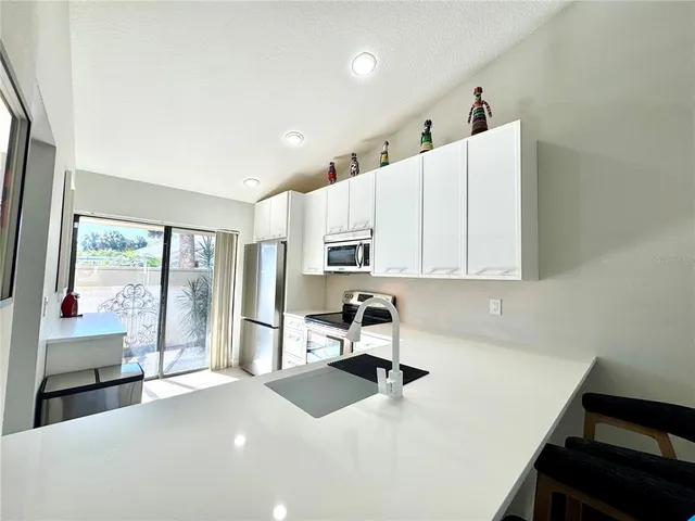a living room with furniture and large flat screen tv