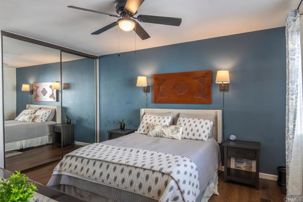 4872 Tarragon Drive Oceanside, CA 92057 - Photo 14 of 25 a bedroom with a bed and a chandelier