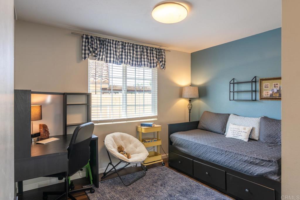 4872 Tarragon Drive Oceanside, CA 92057 - Photo 18 of 25 a bedroom with a bed and wooden floor