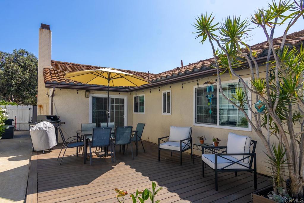 4872 Tarragon Drive Oceanside, CA 92057 - Photo 20 of 25 a patio with wooden table and chairs