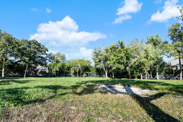 a view of yard with seating area and trees around