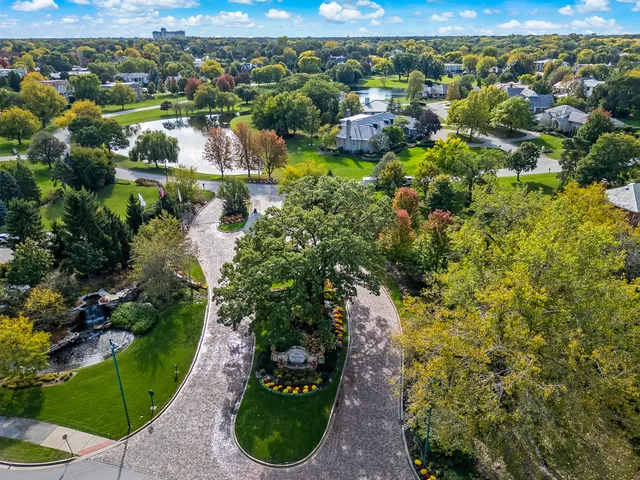 an aerial view of a pool patio chairs and fire pit