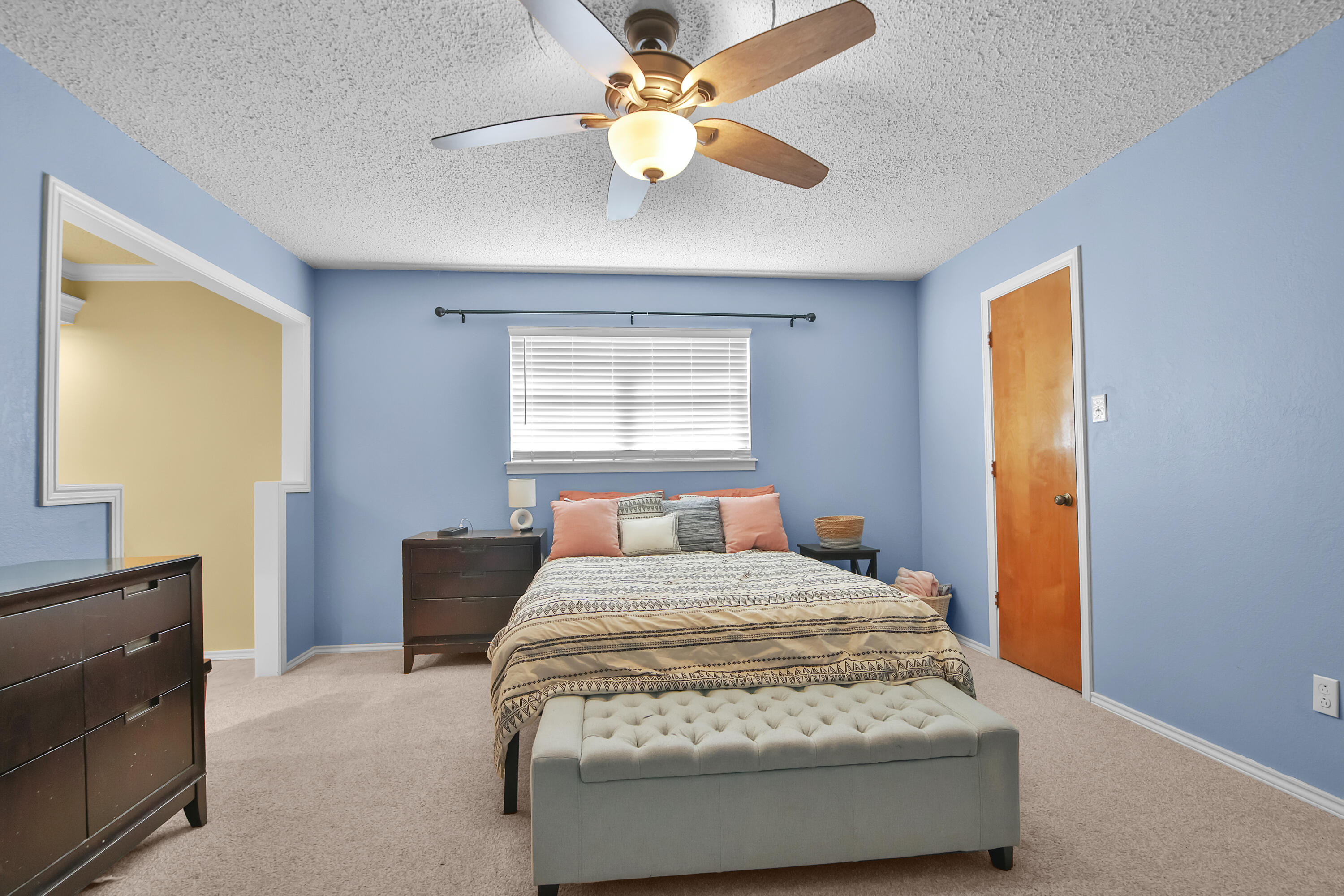 4805 73rd Street Lubbock, TX 79424 - Photo 13 of 26 a bed sitting in a bedroom next to a window