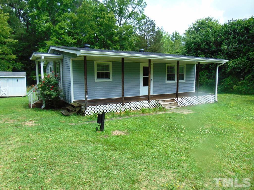 182 Young Road Angier, NC 27501 - Photo 1 of 13 a front view of house with a garden and porch
