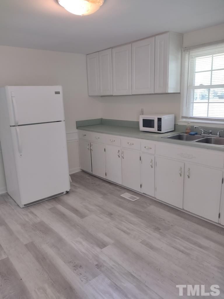 182 Young Road Angier, NC 27501 - Photo 8 of 13 a kitchen with cabinets appliances a sink and a window
