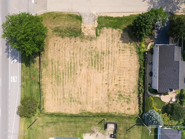 an aerial view of a house with a lake view