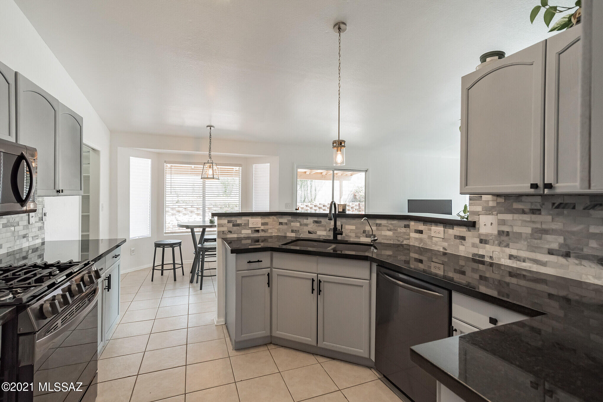 9671 East Azuma Way Tucson, AZ 85747 - Photo 7 of 31 a kitchen with a sink stove and cabinets