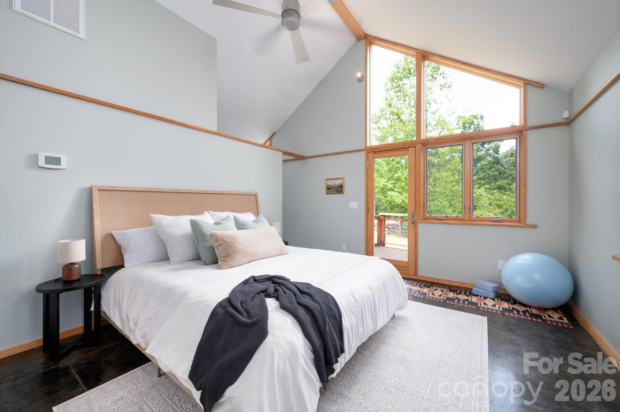 588 Long Branch Road Swannanoa, NC 28778 - Photo 17 of 46 a bedroom with a large bed and windows