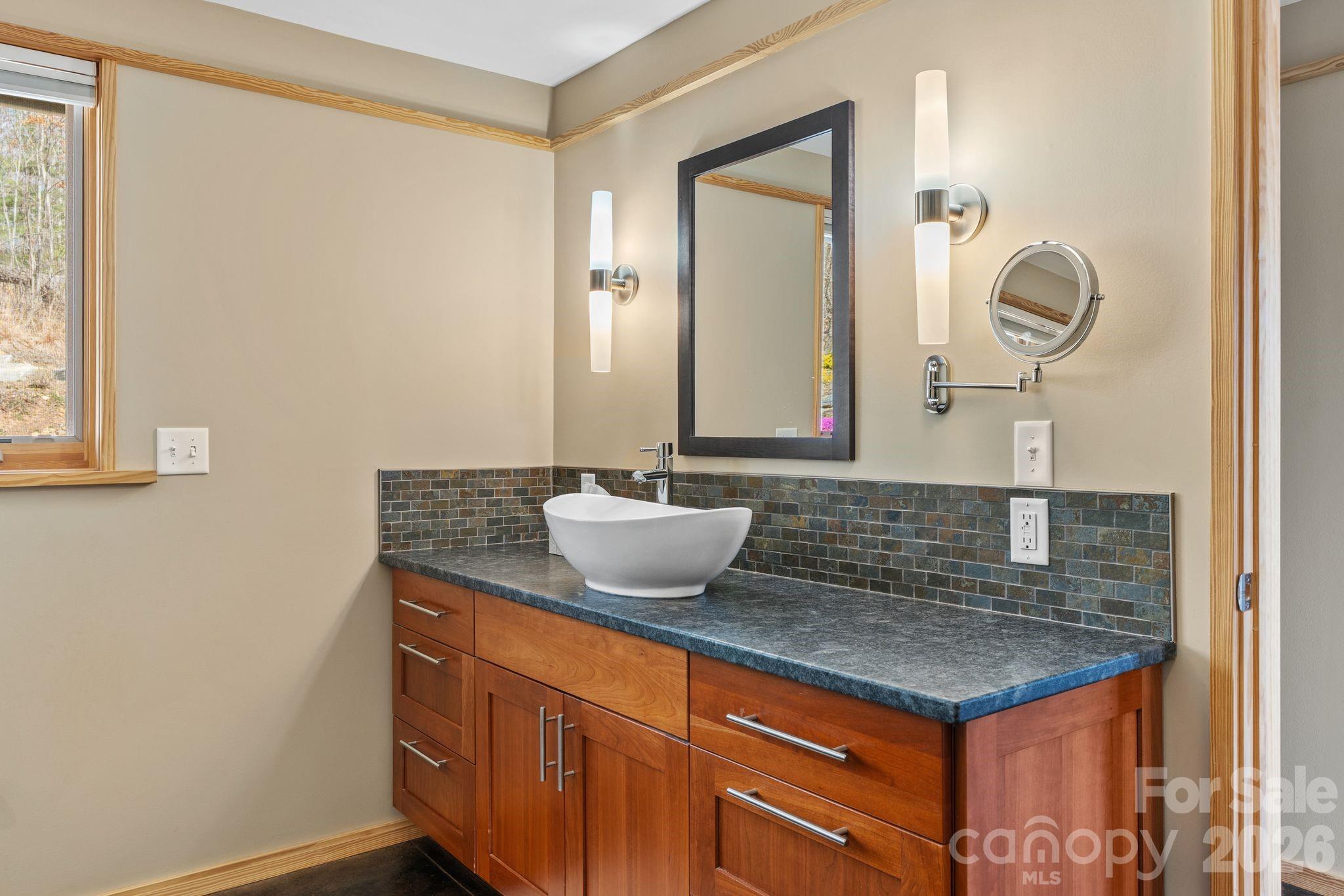588 Long Branch Road Swannanoa, NC 28778 - Photo 19 of 46 a bathroom with a granite countertop sink and a mirror
