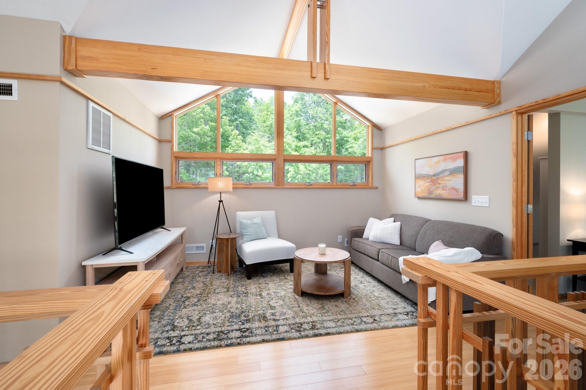 588 Long Branch Road Swannanoa, NC 28778 - Photo 23 of 46 a living room with furniture and a flat screen tv