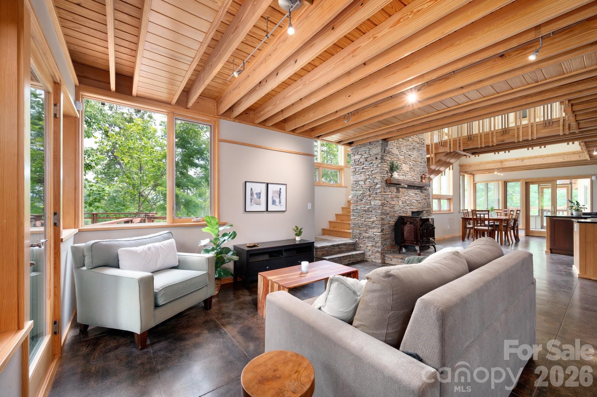 588 Long Branch Road Swannanoa, NC 28778 - Photo 3 of 46 a living room with furniture a fireplace and a large window
