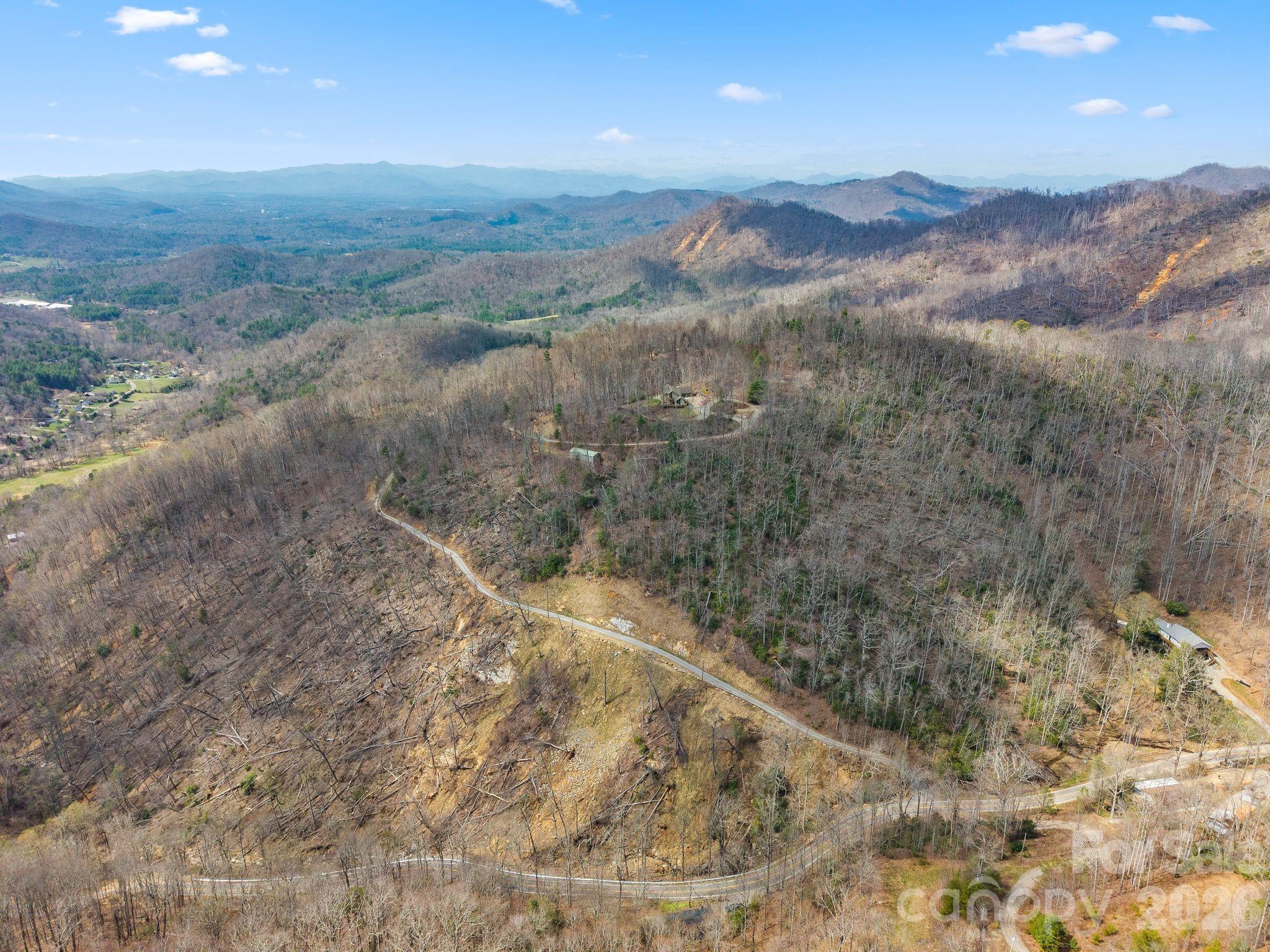 588 Long Branch Road Swannanoa, NC 28778 - Photo 43 of 46 a view of a dry yard with mountains in the background