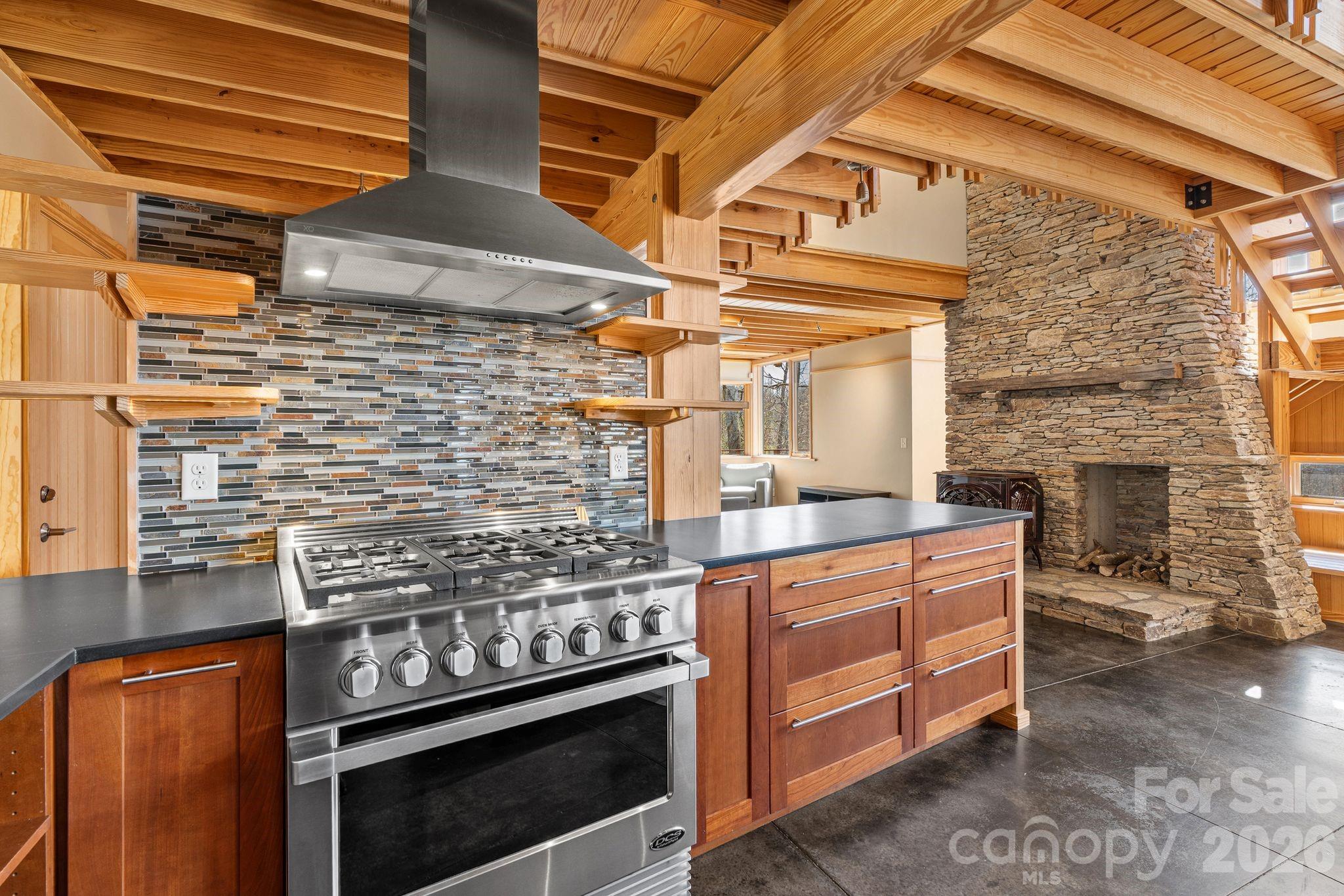 588 Long Branch Road Swannanoa, NC 28778 - Photo 9 of 46 a kitchen with stainless steel appliances granite countertop a stove and a wooden cabinets