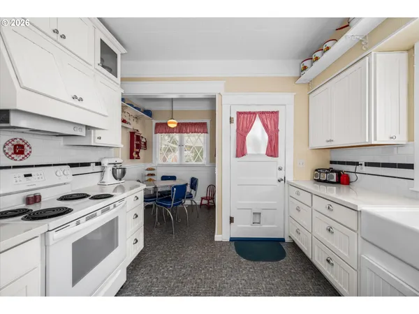 a kitchen with cabinets and window