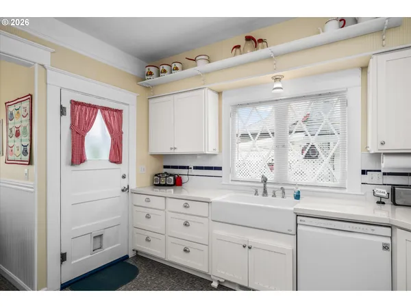 a kitchen with cabinets appliances and a window