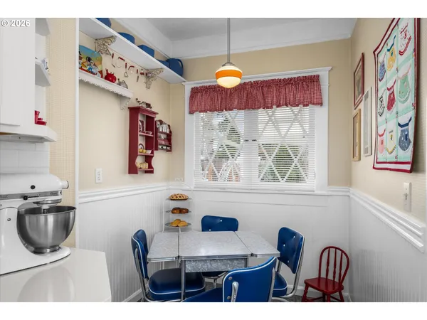 a bathroom with a sink a stove a window and a mirror
