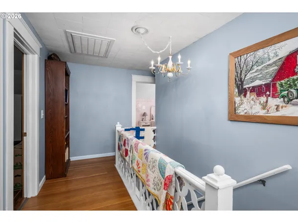 a view of a hallway to a livingroom with furniture