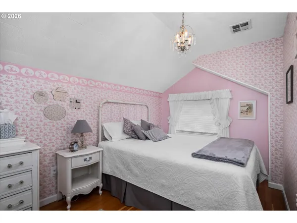 a bedroom with a bed and a chandelier