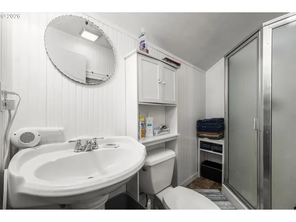 a bathroom with a sink mirror and a toilet
