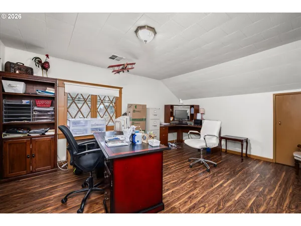 a workspace with furniture and wooden floor