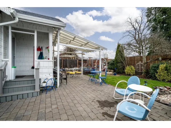 a view of a house with backyard porch and sitting area