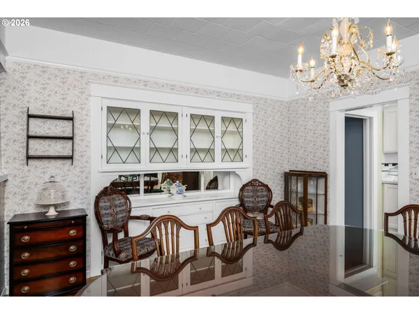 a view of a dining room with furniture and chandelier