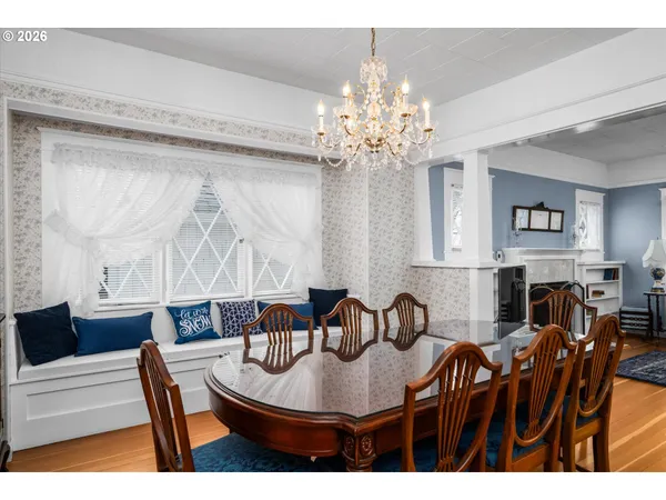a view of a dining room with furniture and chandelier
