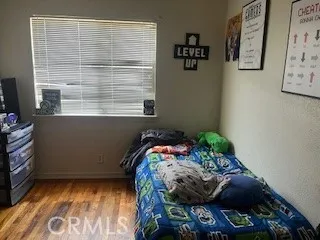 a bed sitting in a bedroom next to a window